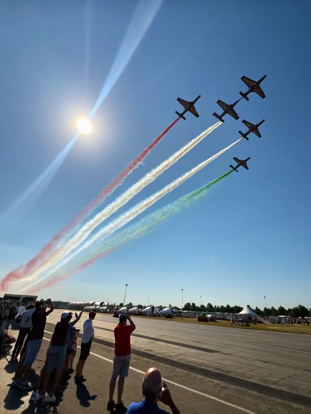 An aerial view of a small group of aircraft flying in formation over the French countryside, showcasing the beauty of flight and the camaraderie of the Aero Club de Saintes members.